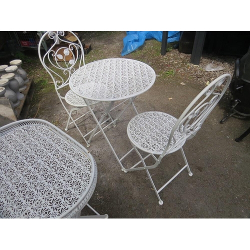 604 - A FOLD AWAY WROUGHT IRON BISTRO SET WITH TWO CHAIRS AND A SIDE TABLE