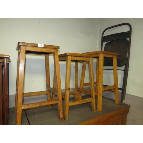 750 - Three mid century wooden stools together with an industrial folding style chair