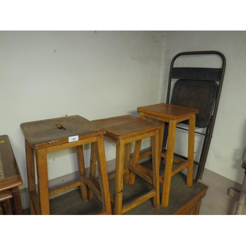 750 - Three mid century wooden stools together with an industrial folding style chair