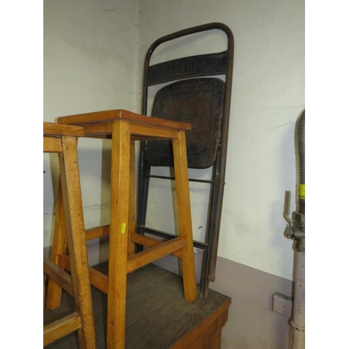 750 - Three mid century wooden stools together with an industrial folding style chair