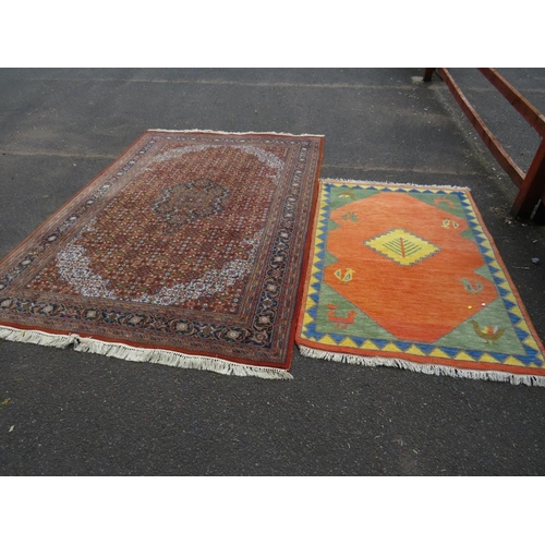 757 - A large Eastern woollen rug together with a smaller modern woollen rug