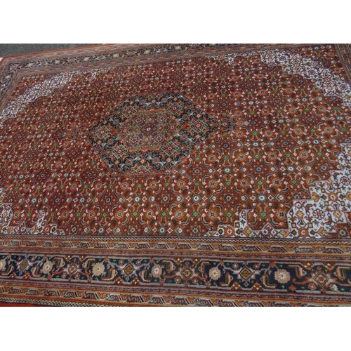 757 - A large Eastern woollen rug together with a smaller modern woollen rug