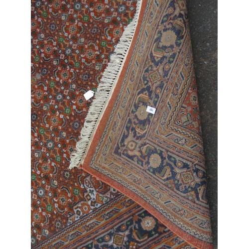 757 - A large Eastern woollen rug together with a smaller modern woollen rug