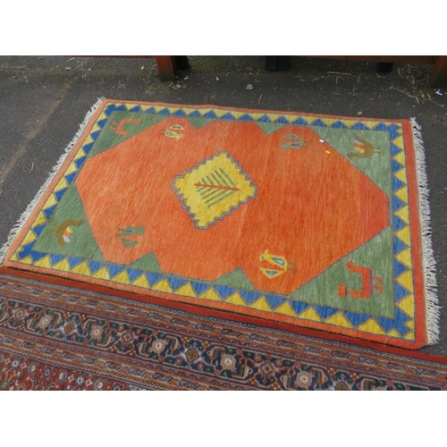 757 - A large Eastern woollen rug together with a smaller modern woollen rug