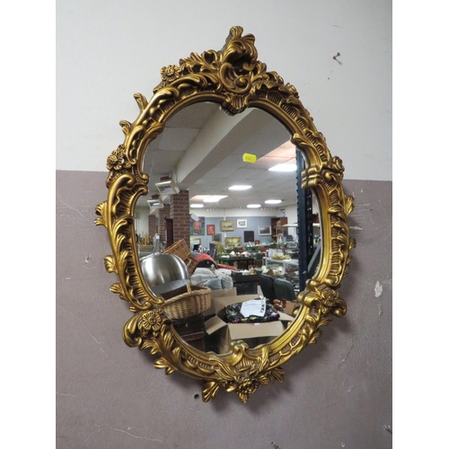 761 - A modern arched cream wall mirror together with an oval gilt example