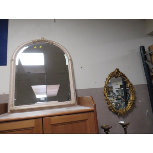 761 - A modern arched cream wall mirror together with an oval gilt example