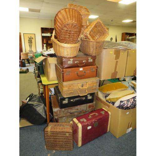 765 - A large collection of vintage suitcases, wicker hampers and baskets