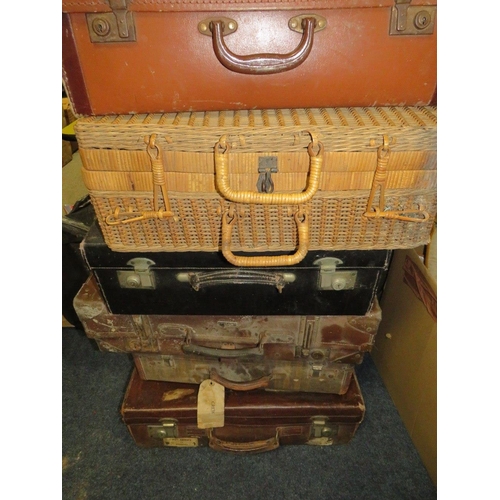 765 - A large collection of vintage suitcases, wicker hampers and baskets