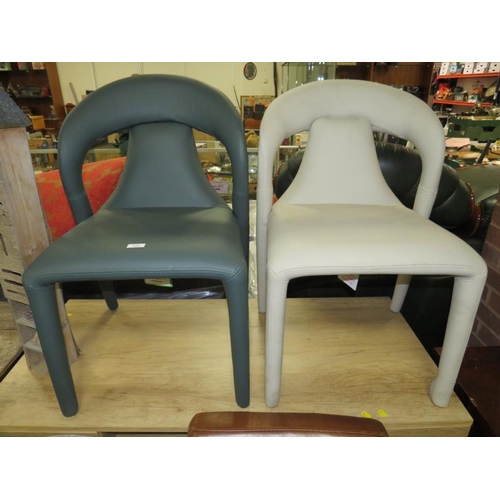 775 - A pair of modern leather upholstered designer style dining chairs