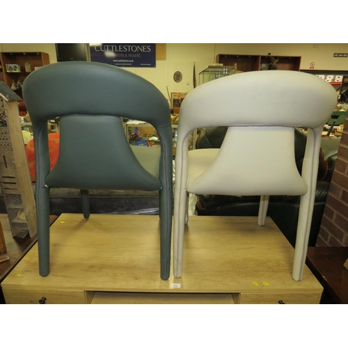 775 - A pair of modern leather upholstered designer style dining chairs