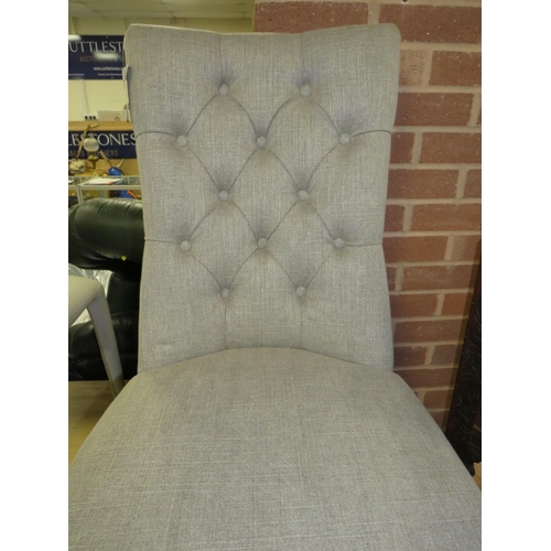 777 - A modern grey upholstered button backed dining chair