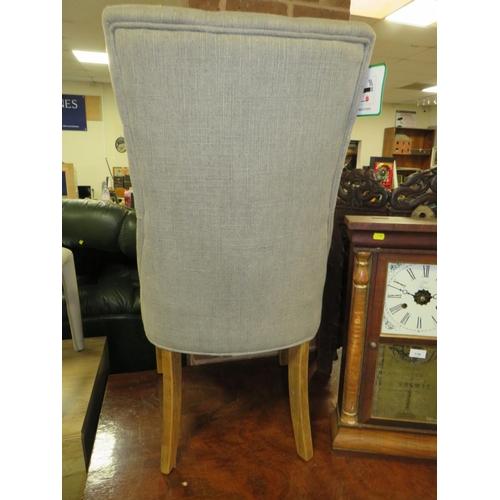 777 - A modern grey upholstered button backed dining chair