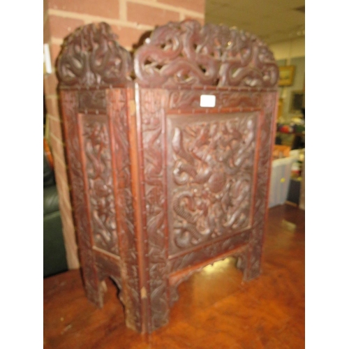 779 - A carved Eastern hardwood fire screen with dragon detail