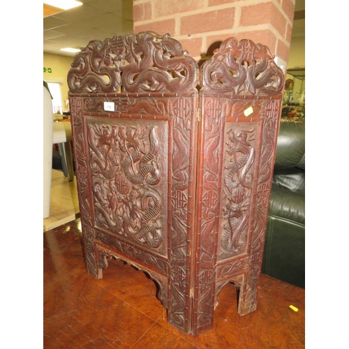 779 - A carved Eastern hardwood fire screen with dragon detail