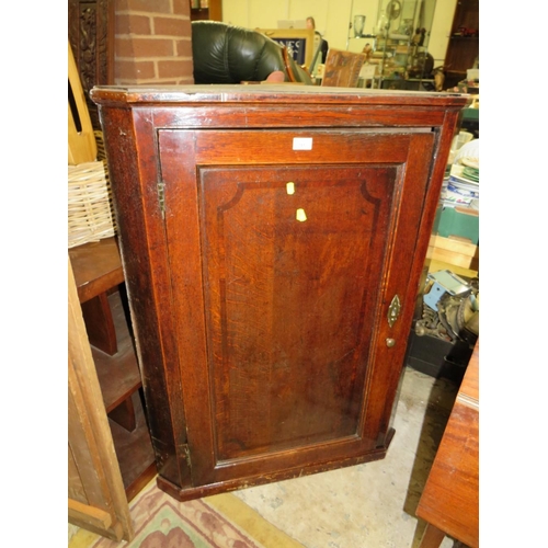 781 - A Georgian oak cross banded hanging corner cupboard