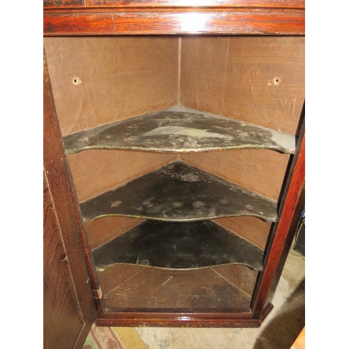 781 - A Georgian oak cross banded hanging corner cupboard