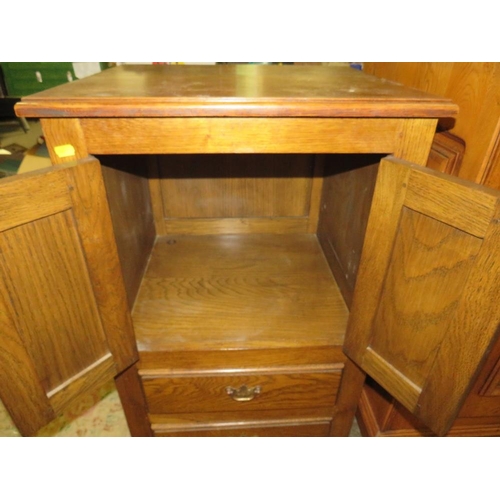 792 - A small oak two door cabinet with two drawers below