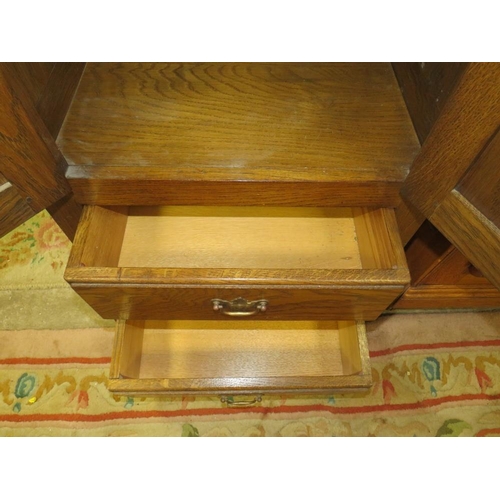 792 - A small oak two door cabinet with two drawers below