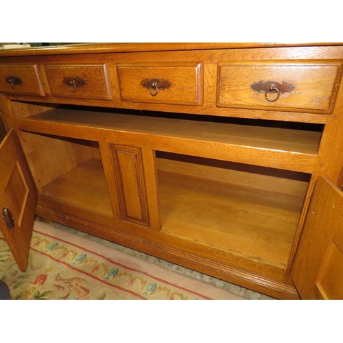 792 - A small oak two door cabinet with two drawers below