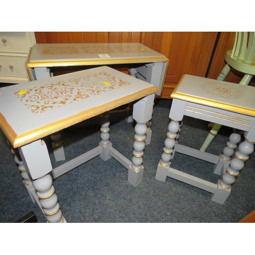 809 - A NEST OF PAINTED OAK TABLES