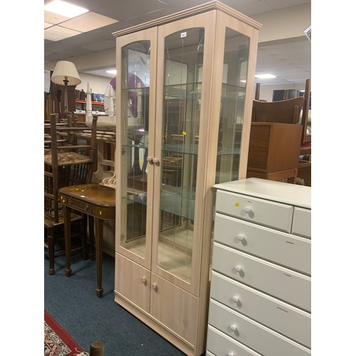 844 - A modern limed and glazed display cabinet with cupboards below