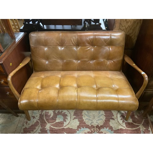 855 - A small modern tan leather brown, two seater settee W 122 cm