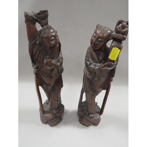 312 - A PAIR OF ORIENTAL STYLE CARVED HARDWOOD FIGURES