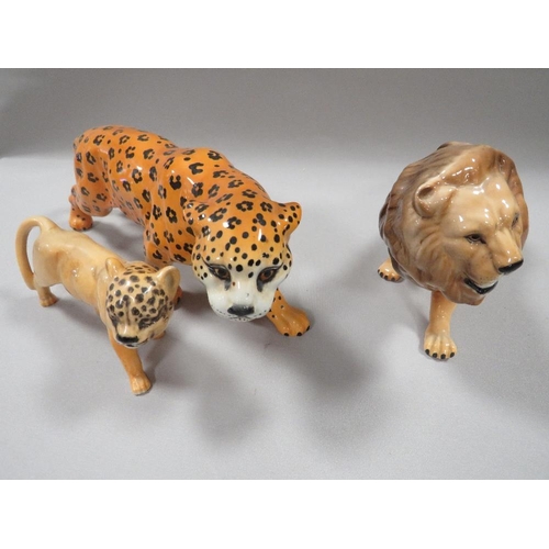 338 - A BESWICK FIGURE OF A LION, A LEOPARD AND ANOTHER (3)