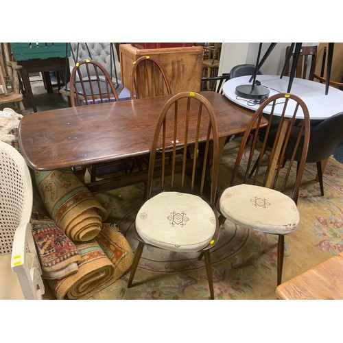 878 - A dark Ercol style refectory dining table with four hoop back chairs