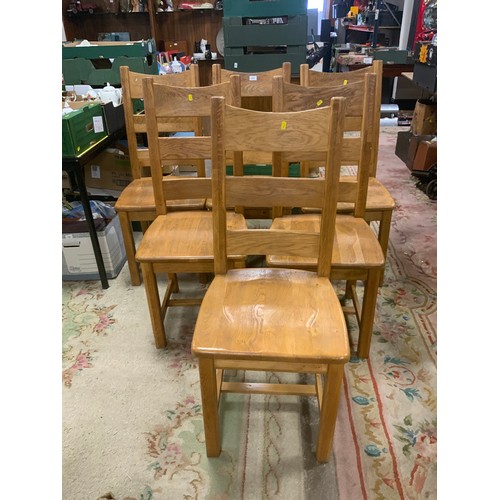 879 - A huge circular, heavy oak dining table together with six heavy oak chairs Dia. 190 cm