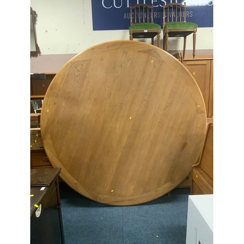 879 - A huge circular, heavy oak dining table together with six heavy oak chairs Dia. 190 cm