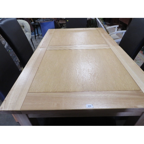 839 - A modern light oak, extending dining table and six leather style dining chairs