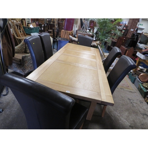 839 - A modern light oak, extending dining table and six leather style dining chairs