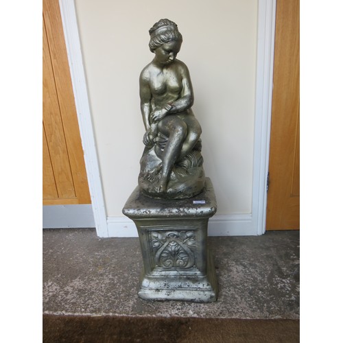 605A - A GARDEN STATUE ON PLINTH OF A FEMALE FIGURE SEATED ON A ROCK, H 94 cm