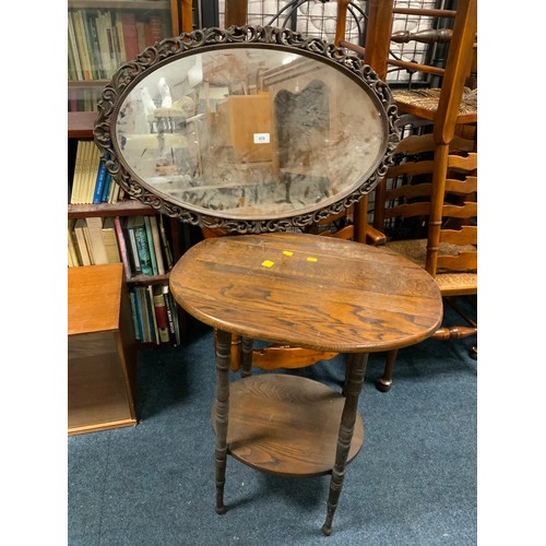 819 - A carved oak wall mirror together with an oak occasional table