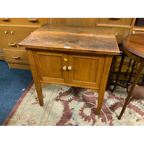 813 - A small oak two door cabinet with marked top