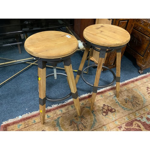 807 - A pair of modern swivel adjustable wooden stools with cast metal fittings