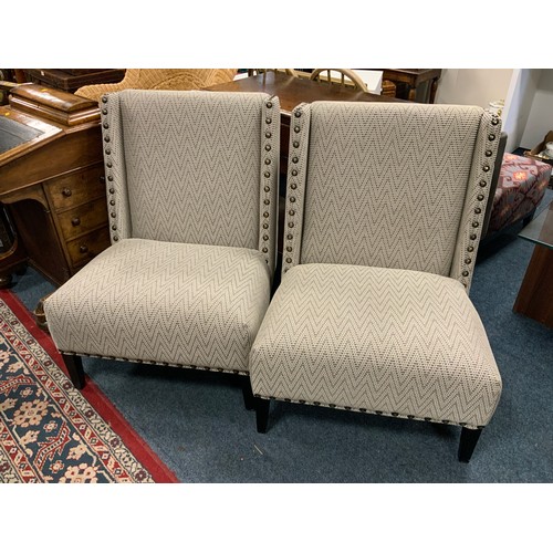 802 - A pair of modern upholstered studded large chairs