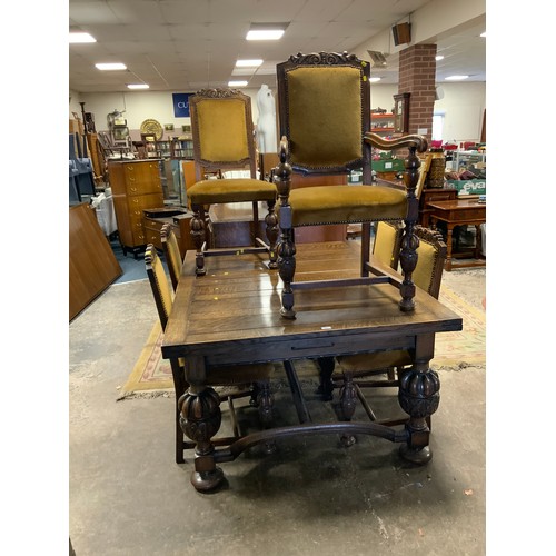 795 - A quality oak heavy draw leaf dining table together with six chairs to include one carver