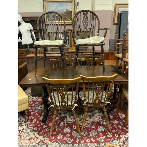 787 - An oak refectory dining table with four chairs, and two other wheel back chairs A/F