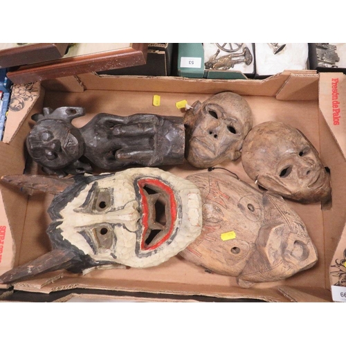 66 - An Indonesian tribal art Dayak Borneo ancestor figure and four Dayak tribal masks