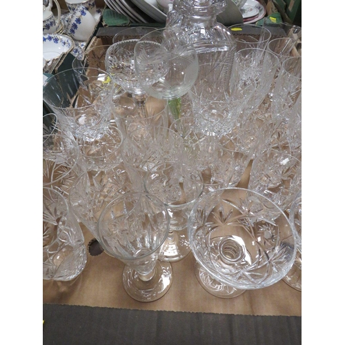 74 - Two trays of assorted cut glass to include decanters etc