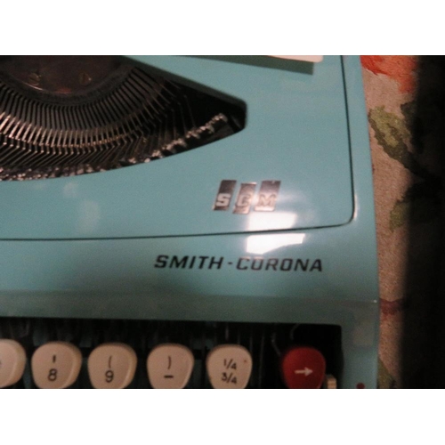 91 - A vintage Smith Corona portable typewriter together with a smaller example