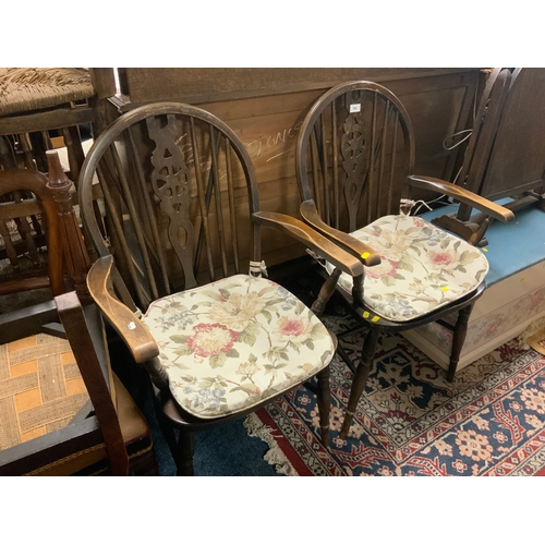 766 - A pair of oak wheel back armchairs to go with an oak triple mirror