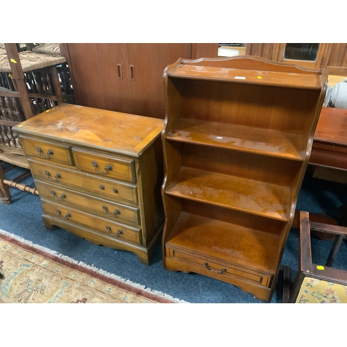 777 - A small reproduction five drawer yew wood chest of drawers together with a waterfall bookcase