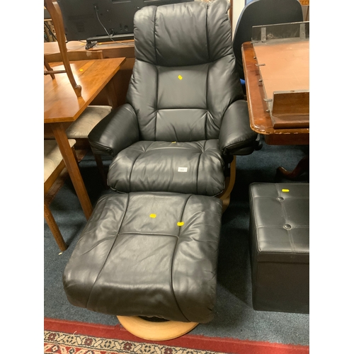 802 - A modern black recliner chair and footstool