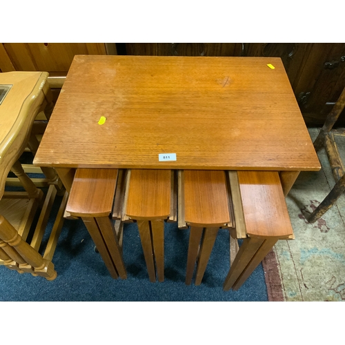 811 - A mid-century teak nest of five tables on castors