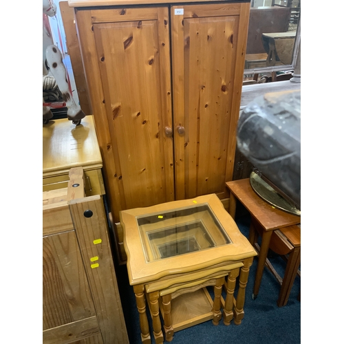 812 - A honey pine tallboy cabinet together with a nest of tables