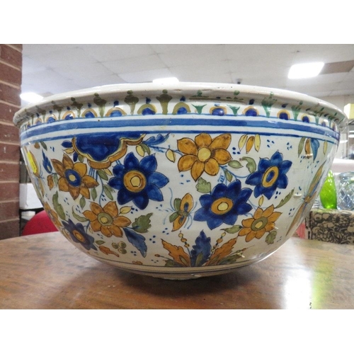 129 - A large Continental Faience style pottery bowl approx Dia. 47cm, A/F