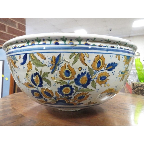 129 - A large Continental Faience style pottery bowl approx Dia. 47cm, A/F